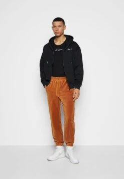 Sean John SCRIPT LOGO ESSENTIAL - Jogginghose - Cognac -Pier One Verkäufe 9a6f2619ac81487dab121142b467fb68